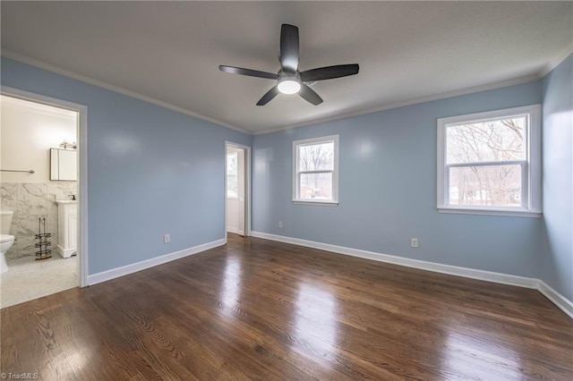 unfurnished bedroom with connected bathroom, ceiling fan, multiple windows, and ornamental molding