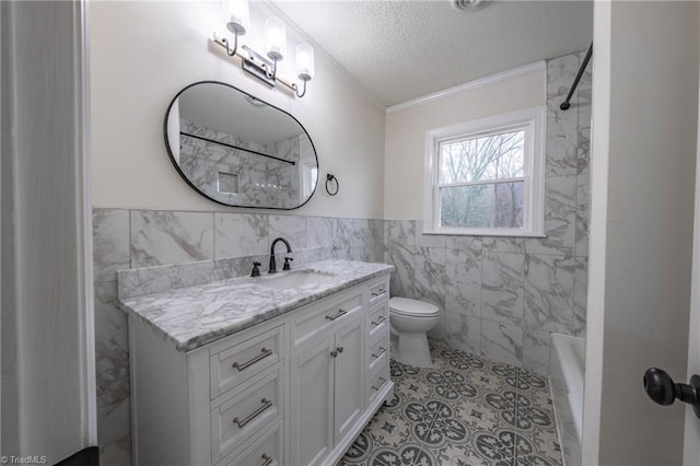 full bathroom featuring ornamental molding, vanity, a textured ceiling, tile walls, and toilet