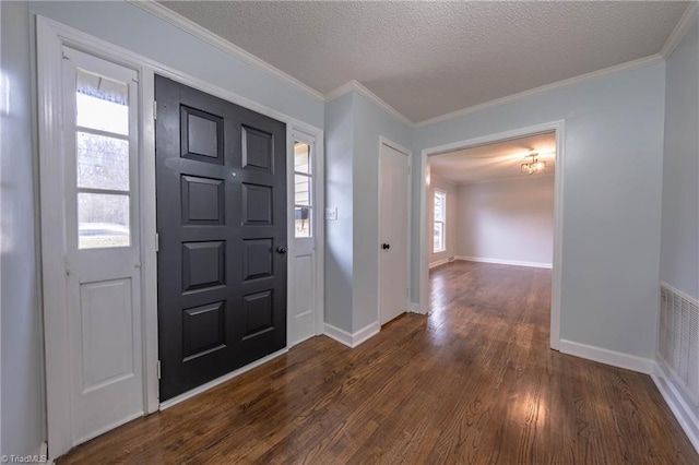 entryway featuring crown molding, a healthy amount of sunlight, dark hardwood / wood-style flooring, and a textured ceiling