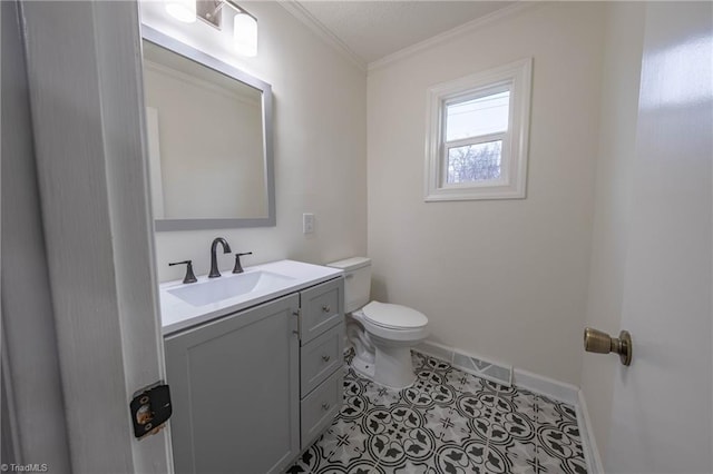 bathroom featuring tile patterned floors, crown molding, vanity, and toilet