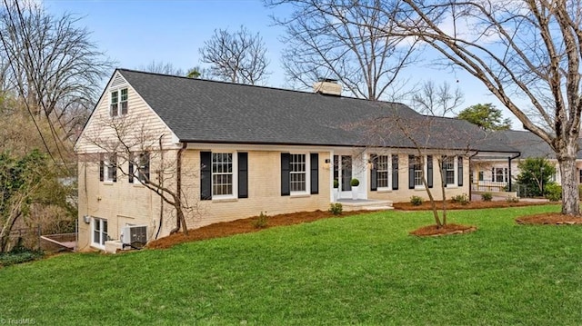 single story home featuring central air condition unit, brick siding, roof with shingles, a front lawn, and a chimney