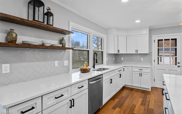 kitchen featuring a sink, ornamental molding, light countertops, and dishwasher