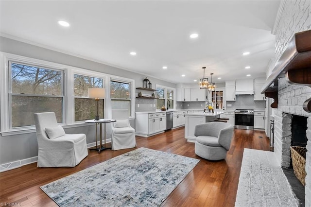 living area featuring a fireplace, visible vents, dark wood-type flooring, and recessed lighting