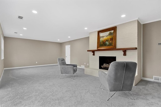 carpeted living room with a large fireplace, baseboards, visible vents, and recessed lighting