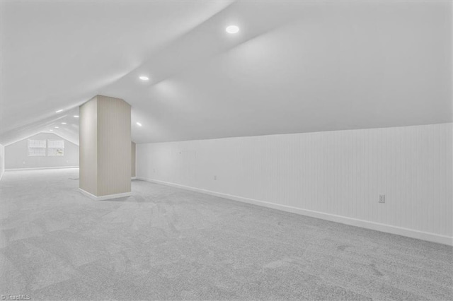 bonus room featuring lofted ceiling, baseboards, and carpet flooring