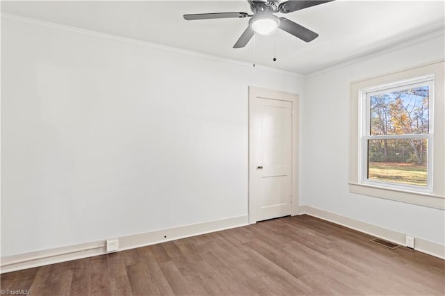 spare room with hardwood / wood-style floors, ceiling fan, and crown molding