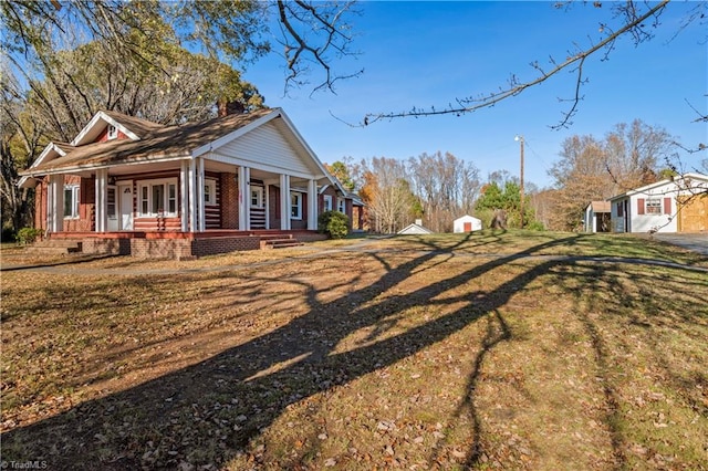 view of side of property featuring a yard and a porch