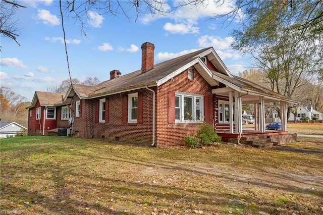 view of home's exterior with a porch, a yard, and cooling unit