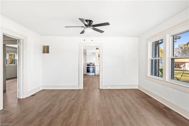 spare room featuring hardwood / wood-style flooring and ceiling fan