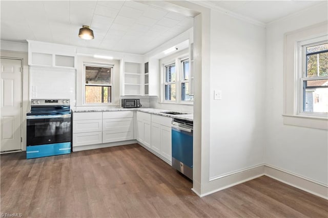 kitchen featuring white cabinets, appliances with stainless steel finishes, light stone counters, and dark wood-type flooring