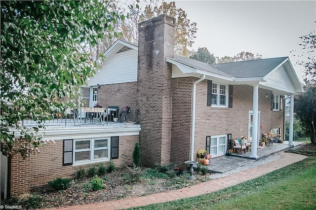 view of property exterior featuring a patio area