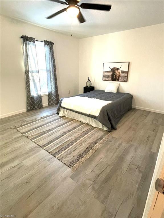 bedroom with hardwood / wood-style flooring and ceiling fan