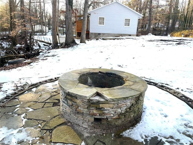 snowy yard featuring a fire pit