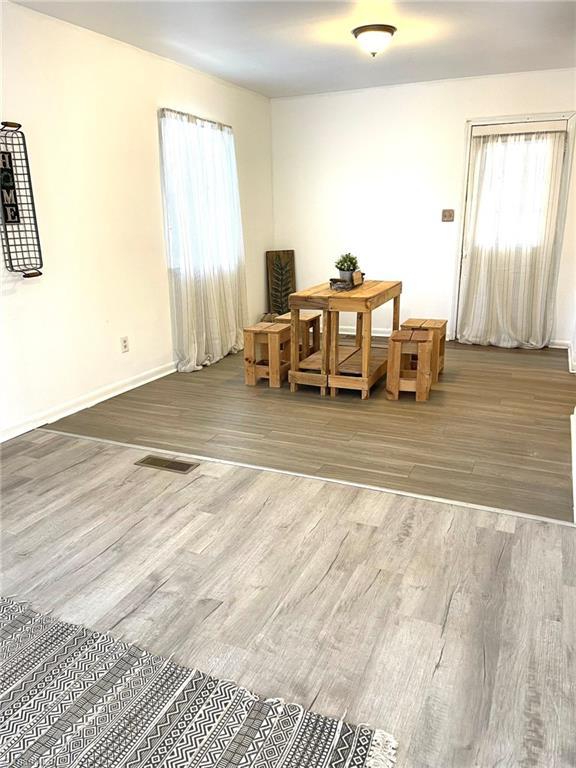 dining space with hardwood / wood-style flooring