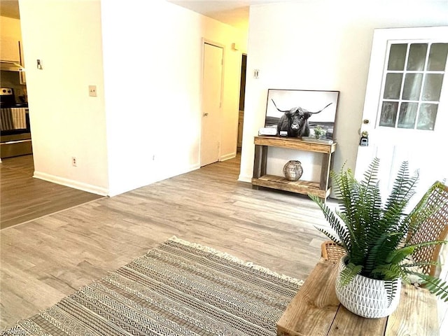 corridor with hardwood / wood-style flooring