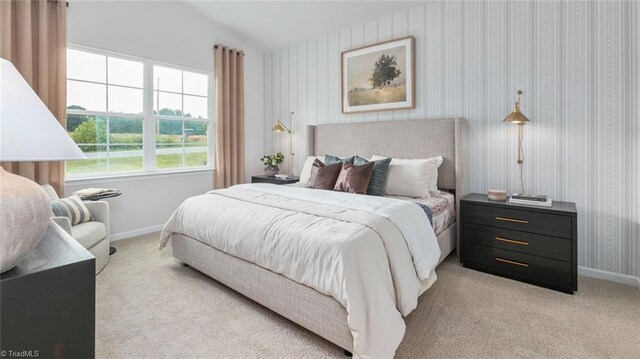 bedroom featuring wallpapered walls, baseboards, vaulted ceiling, and light colored carpet