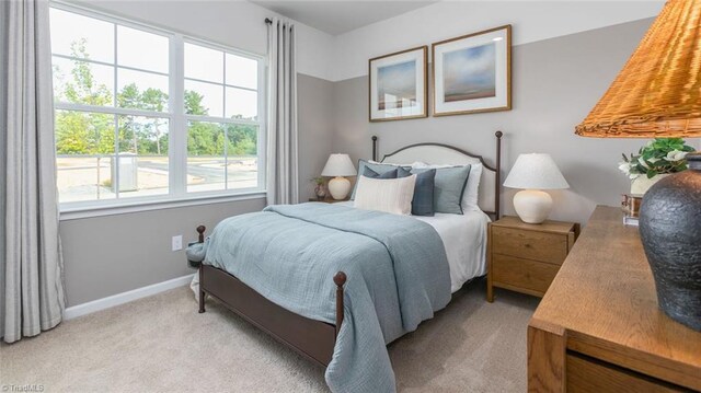 bedroom featuring baseboards and light colored carpet