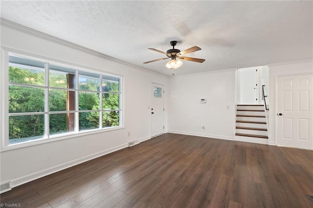 unfurnished living room featuring ceiling fan, dark wood-style floors, stairs, ornamental molding, and baseboards