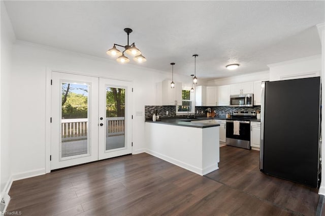 kitchen with appliances with stainless steel finishes, a peninsula, french doors, white cabinets, and tasteful backsplash