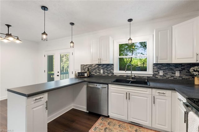 kitchen with stainless steel dishwasher, a sink, a peninsula, dark countertops, and ornamental molding