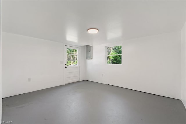 empty room featuring concrete floors and electric panel
