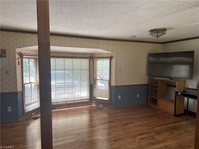 unfurnished living room featuring hardwood / wood-style floors and a textured ceiling