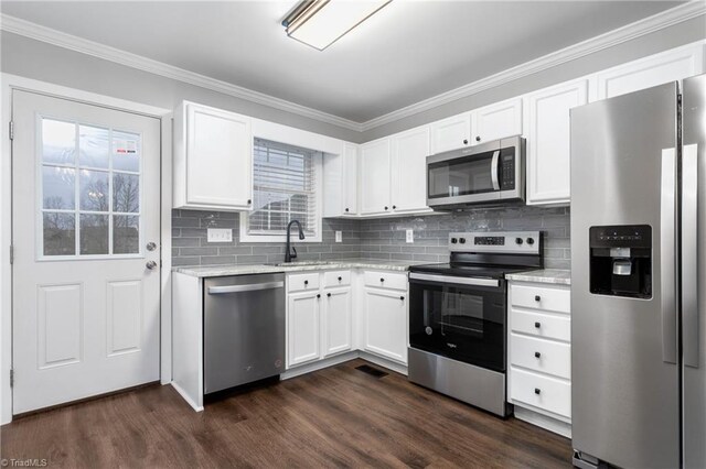 kitchen featuring white cabinets, a healthy amount of sunlight, dark hardwood / wood-style flooring, and stainless steel appliances