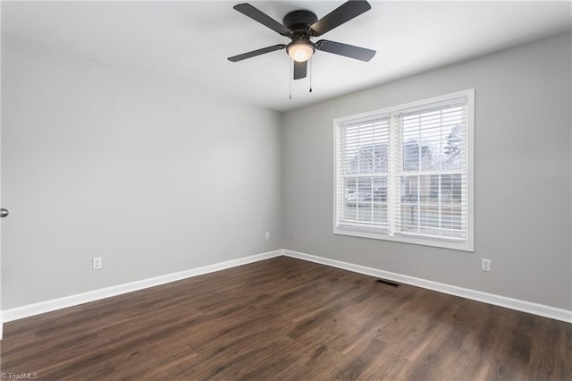 spare room featuring ceiling fan and dark hardwood / wood-style floors