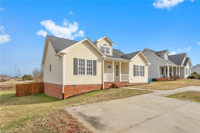 cape cod home with a front lawn and covered porch