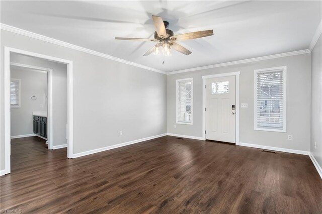 entryway with crown molding, ceiling fan, and dark wood-type flooring