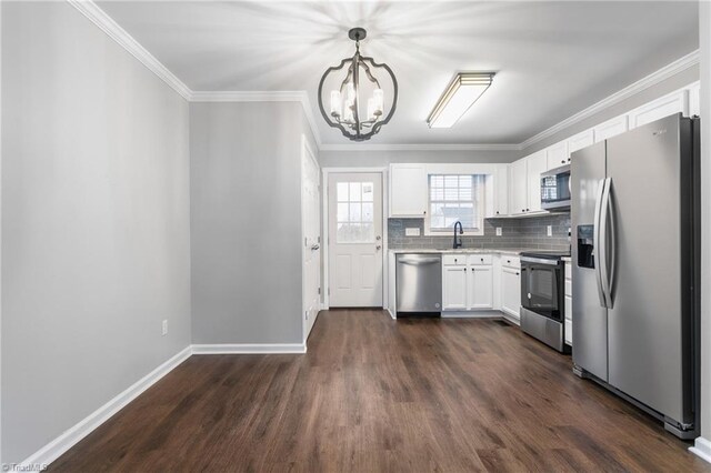 kitchen with stainless steel appliances, sink, an inviting chandelier, white cabinets, and hanging light fixtures