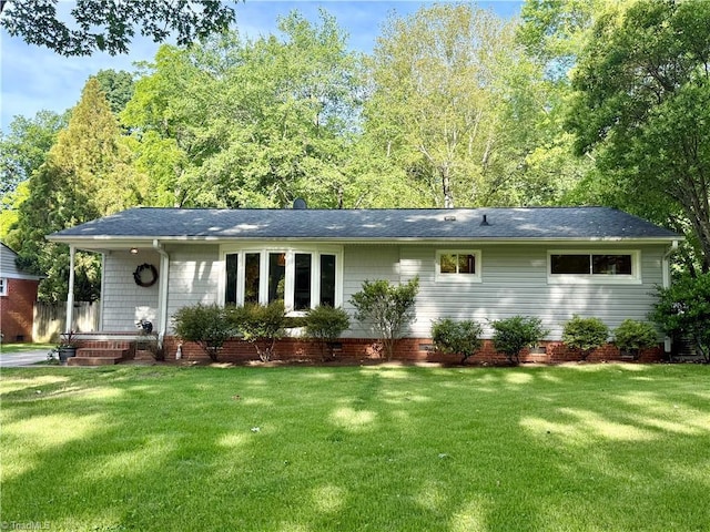 2909 Shamrock Dr, Greensboro, NC 27408 - view of front of house featuring a front yard and a shingled roof