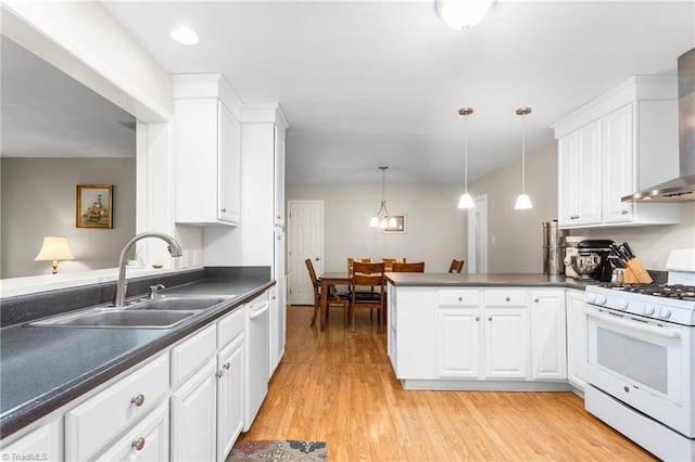 2909 Shamrock Dr, Greensboro, NC 27408 - kitchen featuring white appliances, a sink, dark countertops, a peninsula, and white cabinets