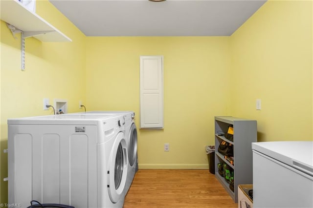 2909 Shamrock Dr, Greensboro, NC 27408 - laundry area with washer and clothes dryer, light wood finished floors, and baseboards