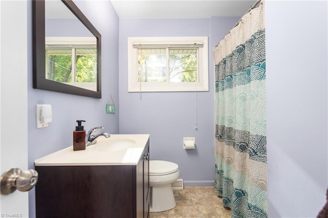 2909 Shamrock Dr, Greensboro, NC 27408 - bathroom with toilet, vanity, baseboards, and a shower with shower curtain