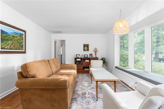 2909 Shamrock Dr, Greensboro, NC 27408 - living area with plenty of natural light, wood finished floors, and baseboards