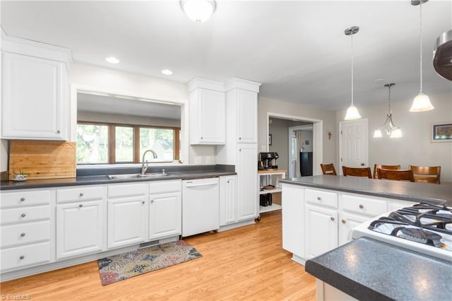 2909 Shamrock Dr, Greensboro, NC 27408 - kitchen with white appliances, a sink, dark countertops, white cabinets, and recessed lighting