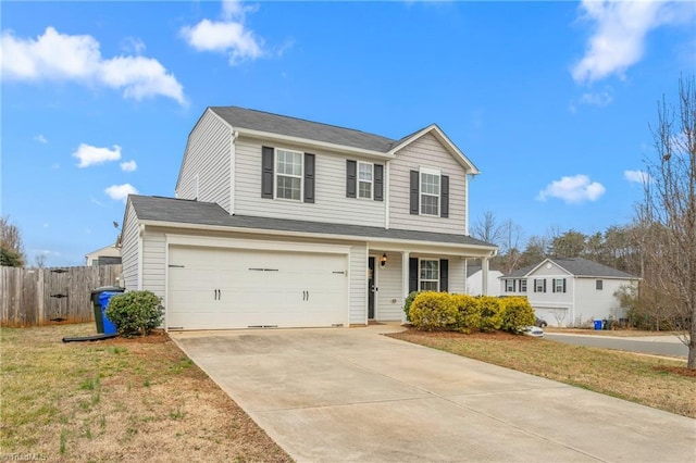 traditional-style home with a garage, driveway, a front lawn, and fence