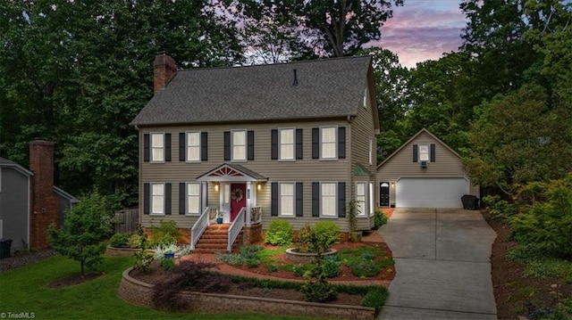 1608 Fox Hollow Rd, Greensboro, NC 27410 - colonial-style house with a garage, an outbuilding, and a chimney