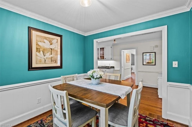 1608 Fox Hollow Rd, Greensboro, NC 27410 - dining space with wainscoting, wood finished floors, ornamental molding, and a decorative wall