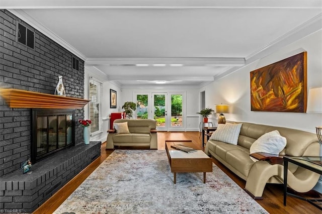 1608 Fox Hollow Rd, Greensboro, NC 27410 - living room featuring wood finished floors, a brick fireplace, crown molding, and beamed ceiling