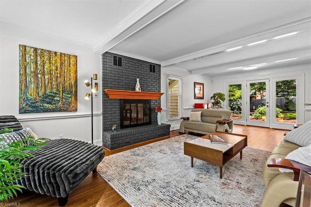 1608 Fox Hollow Rd, Greensboro, NC 27410 - living room with beam ceiling, wood finished floors, and a brick fireplace