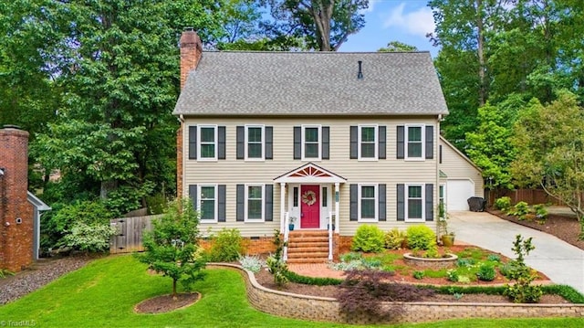 1608 Fox Hollow Rd, Greensboro, NC 27410 - colonial inspired home with a chimney, concrete driveway, crawl space, and a garage