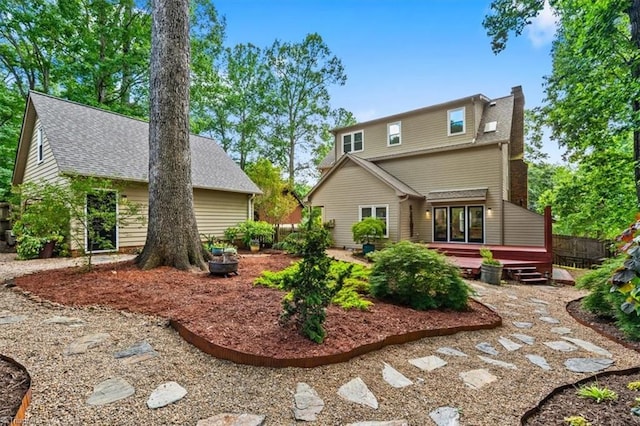 1608 Fox Hollow Rd, Greensboro, NC 27410 - rear view of house with a wooden deck, a chimney, and roof with shingles