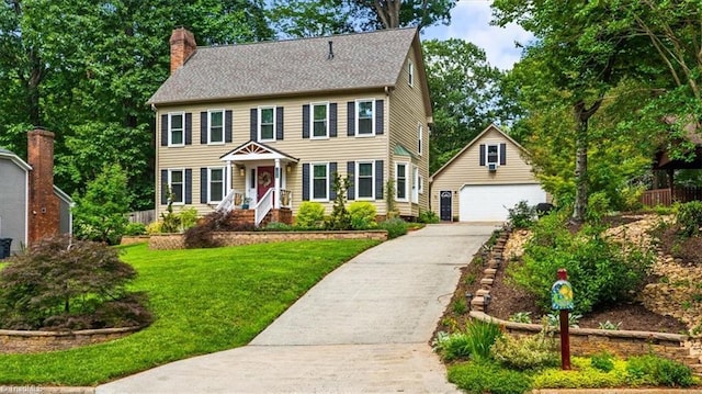 1608 Fox Hollow Rd, Greensboro, NC 27410 - colonial house featuring an outdoor structure, a chimney, a garage, and a front yard
