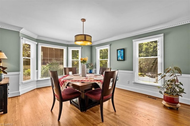 1608 Fox Hollow Rd, Greensboro, NC 27410 - dining space with crown molding, light wood finished floors, and wainscoting