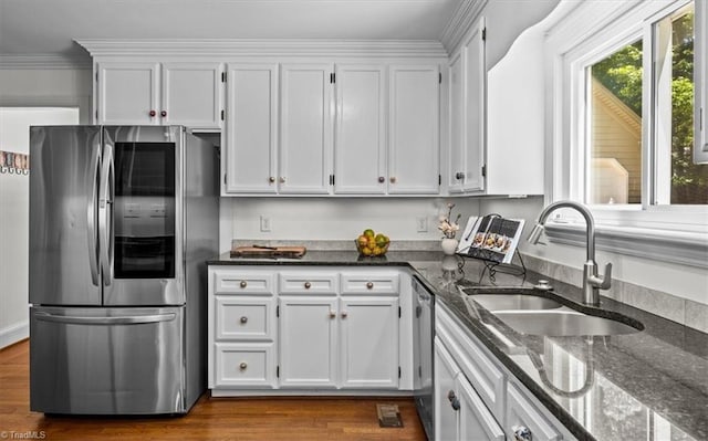 1608 Fox Hollow Rd, Greensboro, NC 27410 - kitchen featuring appliances with stainless steel finishes, white cabinetry, dark stone counters, and dark wood finished floors