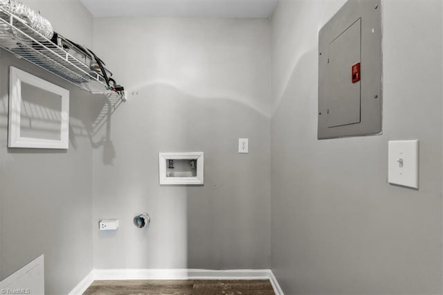 clothes washing area with laundry area, electric panel, wood finished floors, baseboards, and hookup for a washing machine
