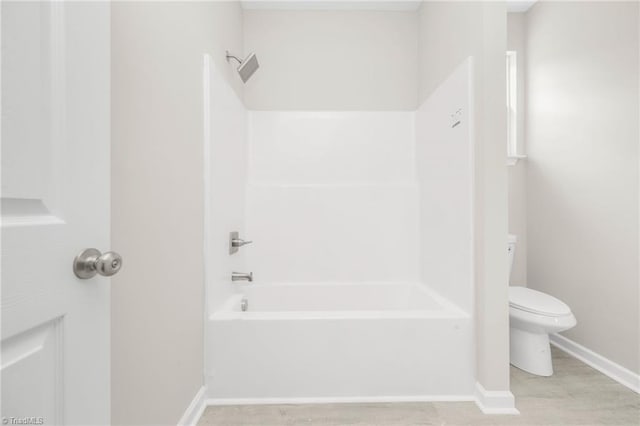 bathroom featuring  shower combination, toilet, baseboards, and wood finished floors