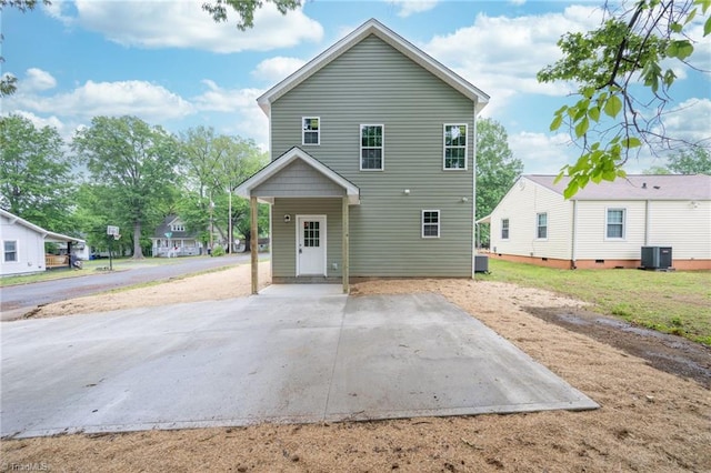 back of house with central AC